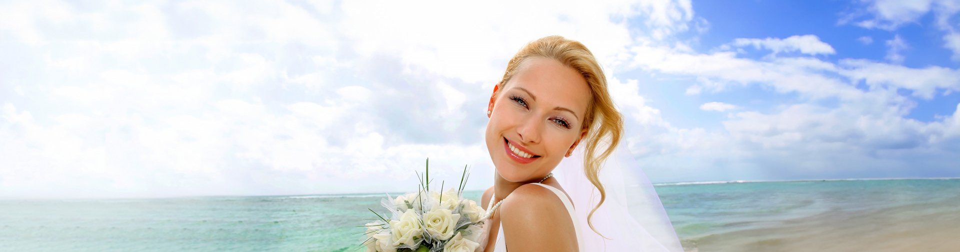 Woman posing on beach in wedding gown