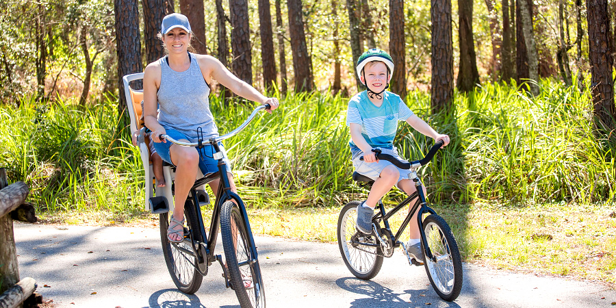 Mother and son taking a bike ride on a natural trail.