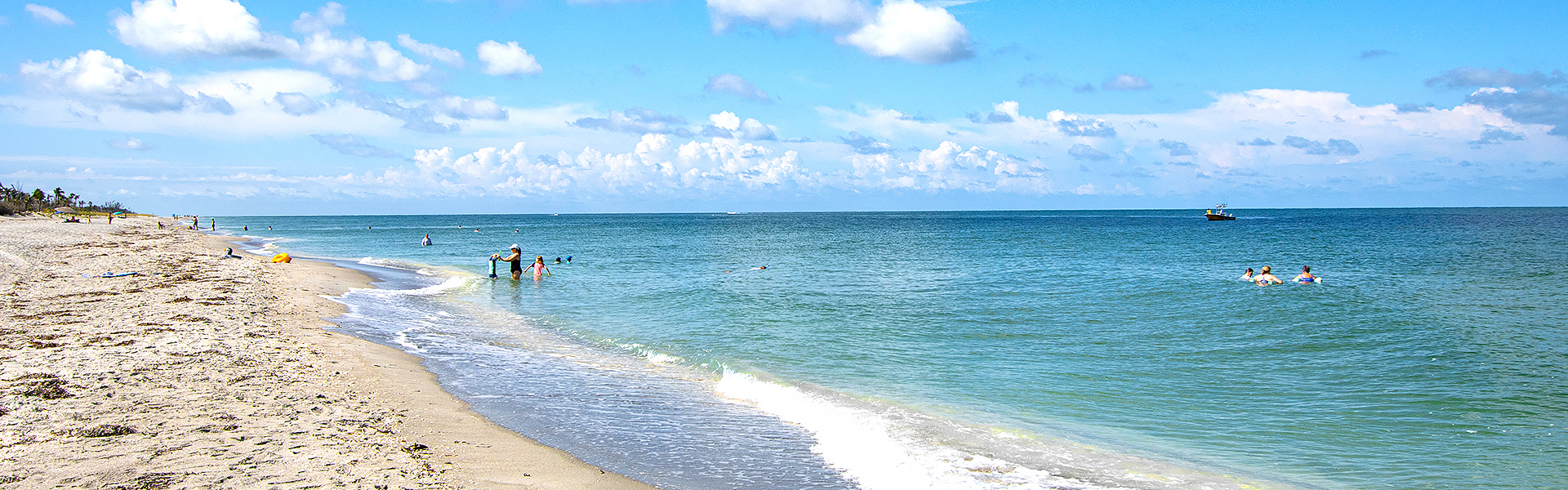 People in the water on the beaches of Sanibel.
