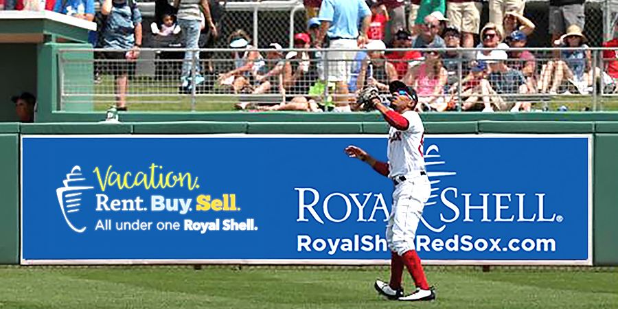 Red Sox outfielder catching ball in front of Royal Shell Sign